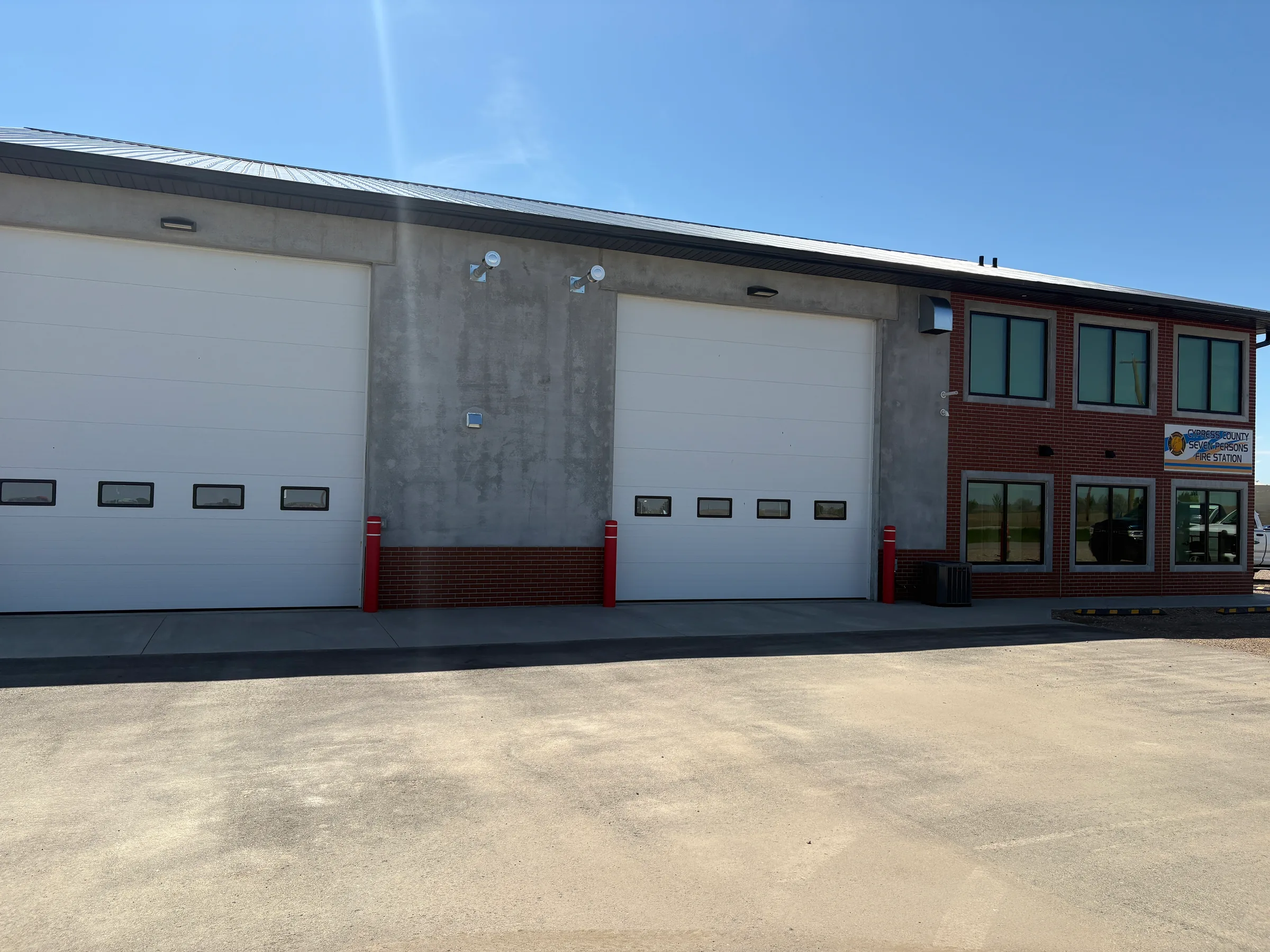 Apparatus bay doors and brick office wing of the completed fire station at Seven Persons Fire Hall, built by Premiere Builders